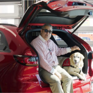 Duke the service dog in back of SUV with Michael Palmer at Mazda Corpus Christi